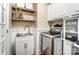 Bright laundry room with built-in cabinets, a sink, and modern washer and dryer at 217 Ridge Reserve Dr, Lake Wylie, SC 29710