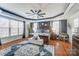 Main bedroom with hardwood floors, large windows, and ceiling fan at 217 Ridge Reserve Dr, Lake Wylie, SC 29710