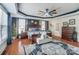 Main bedroom with hardwood floors, large windows, and ceiling fan at 217 Ridge Reserve Dr, Lake Wylie, SC 29710