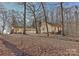 Large lot in backyard with plenty of mature trees; two separate structures visible at 2205 E Brief Rd, Monroe, NC 28110