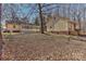 Backyard with multiple buildings on the property, featuring a large lot with mature trees at 2205 E Brief Rd, Monroe, NC 28110