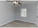 Clean bedroom with hardwood floors, new ceiling fan, and large window at 2205 E Brief Rd, Monroe, NC 28110