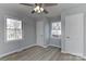 Well-lit bedroom featuring hardwood floors, a ceiling fan and two windows at 2205 E Brief Rd, Monroe, NC 28110