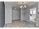 Bright dining room with chandelier, hardwood floors, and natural light at 2205 E Brief Rd, Monroe, NC 28110