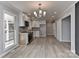 Open concept kitchen and dining area with modern lighting and neutral paint at 2205 E Brief Rd, Monroe, NC 28110