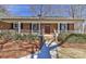 Charming brick home featuring a welcoming front porch and a meticulously maintained yard at 2205 E Brief Rd, Monroe, NC 28110