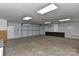 Spacious garage includes a large garage door, workbench area, and overhead lighting at 2205 E Brief Rd, Monroe, NC 28110