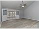 Bright living room featuring a vaulted ceiling and hardwood floors flowing into a sunroom at 2205 E Brief Rd, Monroe, NC 28110