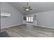 Bright living room features a vaulted ceiling, hardwood floors, and an elegant fireplace at 2205 E Brief Rd, Monroe, NC 28110