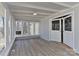 Bright sunroom with hardwood floors and a door leading into the main living area at 2205 E Brief Rd, Monroe, NC 28110