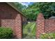 Ornate black gate in brick wall leading to grassy backyard area at 2324 Ryan Conley Ct, Gastonia, NC 28056