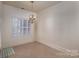 Elegant dining room with hardwood floors, chandelier, and large window at 2324 Ryan Conley Ct, Gastonia, NC 28056