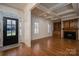 Bright entryway with hardwood floors, fireplace, built-in shelving, and black front door at 2324 Ryan Conley Ct, Gastonia, NC 28056