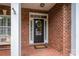 Black front door with a wreath on a brick house at 2324 Ryan Conley Ct, Gastonia, NC 28056