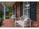 Brick front porch with white benches and landscaping at 2324 Ryan Conley Ct, Gastonia, NC 28056