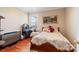 Cozy bedroom with hardwood floors and a vintage bed at 261 Nabors Rd, Statesville, NC 28677