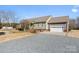 House exterior showcasing a green exterior and gravel driveway at 261 Nabors Rd, Statesville, NC 28677