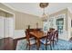 Formal dining room with hardwood floors, chandelier, and adjacent access to outdoor patio at 3024 Ambleside Dr, Fort Mill, SC 29707