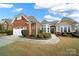 Attractive ranch home features a two-toned exterior and manicured landscaping at 3024 Ambleside Dr, Fort Mill, SC 29707