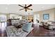 Open living room with hardwood floors, ample seating, and views of the kitchen at 3024 Ambleside Dr, Fort Mill, SC 29707