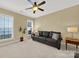 Comfortable living room with a leather couch and ceiling fan at 3024 Ambleside Dr, Fort Mill, SC 29707