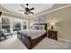 Main bedroom features a king-size bed, ceiling fan, and large windows at 3024 Ambleside Dr, Fort Mill, SC 29707