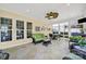 Relaxing sunroom with wicker furniture and tile flooring at 3024 Ambleside Dr, Fort Mill, SC 29707