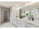 Double vanity bathroom with marble flooring and a soaking tub at 312 Coronado Ave, Matthews, NC 28104