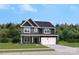 Two-story house with gray siding, stone accents, and a two-car garage at 312 Coronado Ave, Matthews, NC 28104