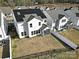 Aerial view of a house with solar panels and a fenced backyard, showcasing energy efficiency and privacy at 3155 Pinehills Way, Mount Holly, NC 28120