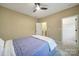 Comfortable bedroom featuring a ceiling fan, carpet, and doors leading to closets at 3155 Pinehills Way, Mount Holly, NC 28120