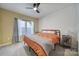 Bright bedroom with a ceiling fan, a window with curtains, and a comfortable bed at 3155 Pinehills Way, Mount Holly, NC 28120