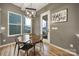 Cozy dining area with a round table, contemporary chandelier, and a door to outdoor living space at 3155 Pinehills Way, Mount Holly, NC 28120