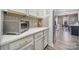 Kitchen counter with stainless steel appliances, white cabinetry, quartz countertops and tile backsplash at 3155 Pinehills Way, Mount Holly, NC 28120