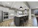 Spacious eat-in kitchen with a large island, pendant lighting, stainless appliances, and white cabinetry at 3155 Pinehills Way, Mount Holly, NC 28120