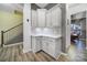 Kitchenette area with white shaker cabinets, quartz countertops, tile backsplash, and stylish fixtures at 3155 Pinehills Way, Mount Holly, NC 28120