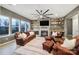 Inviting living room featuring fireplace, built-in shelving, and comfortable leather seating at 3155 Pinehills Way, Mount Holly, NC 28120