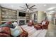 Warm living room with a fireplace, built-in shelves, and comfortable leather seating at 3155 Pinehills Way, Mount Holly, NC 28120