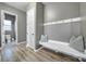 Mudroom with white bench, wall hooks, pillows and access to a powder room at 3155 Pinehills Way, Mount Holly, NC 28120