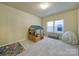 Spacious playroom with carpet, featuring a toy house, play rug, and two windows at 3155 Pinehills Way, Mount Holly, NC 28120