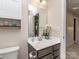 Small bathroom with vanity, toilet, and mirror at 3203 Morgan Clark Rd, Charlotte, NC 28208