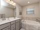 Bathroom with double vanity, soaking tub, and tile flooring at 3203 Morgan Clark Rd, Charlotte, NC 28208