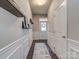 Light and airy entryway with white wainscoting and floating shelves at 3203 Morgan Clark Rd, Charlotte, NC 28208