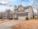 Two-story house with beige siding, gray stone accents, and a two-car garage at 3203 Morgan Clark Rd, Charlotte, NC 28208