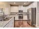 Modern kitchen with white cabinets, granite countertops, and stainless steel appliances at 3203 Morgan Clark Rd, Charlotte, NC 28208