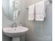 Modern powder room with pedestal sink and chrome fixtures at 3203 Morgan Clark Rd, Charlotte, NC 28208