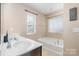 Main bathroom includes a soaking tub, vanity with sink, and window at 3322 Yarmouth Ln, Gastonia, NC 28056