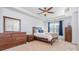 Spacious bedroom with carpeted floors, ceiling fan, and wood furniture at 3322 Yarmouth Ln, Gastonia, NC 28056