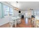 Bright dining room features hardwood floors, a farmhouse table, and a modern chandelier at 3322 Yarmouth Ln, Gastonia, NC 28056