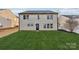 Rear view of a two-story house with a grassy backyard and a white fence at 3366 Table Rock Dr, Gastonia, NC 28052